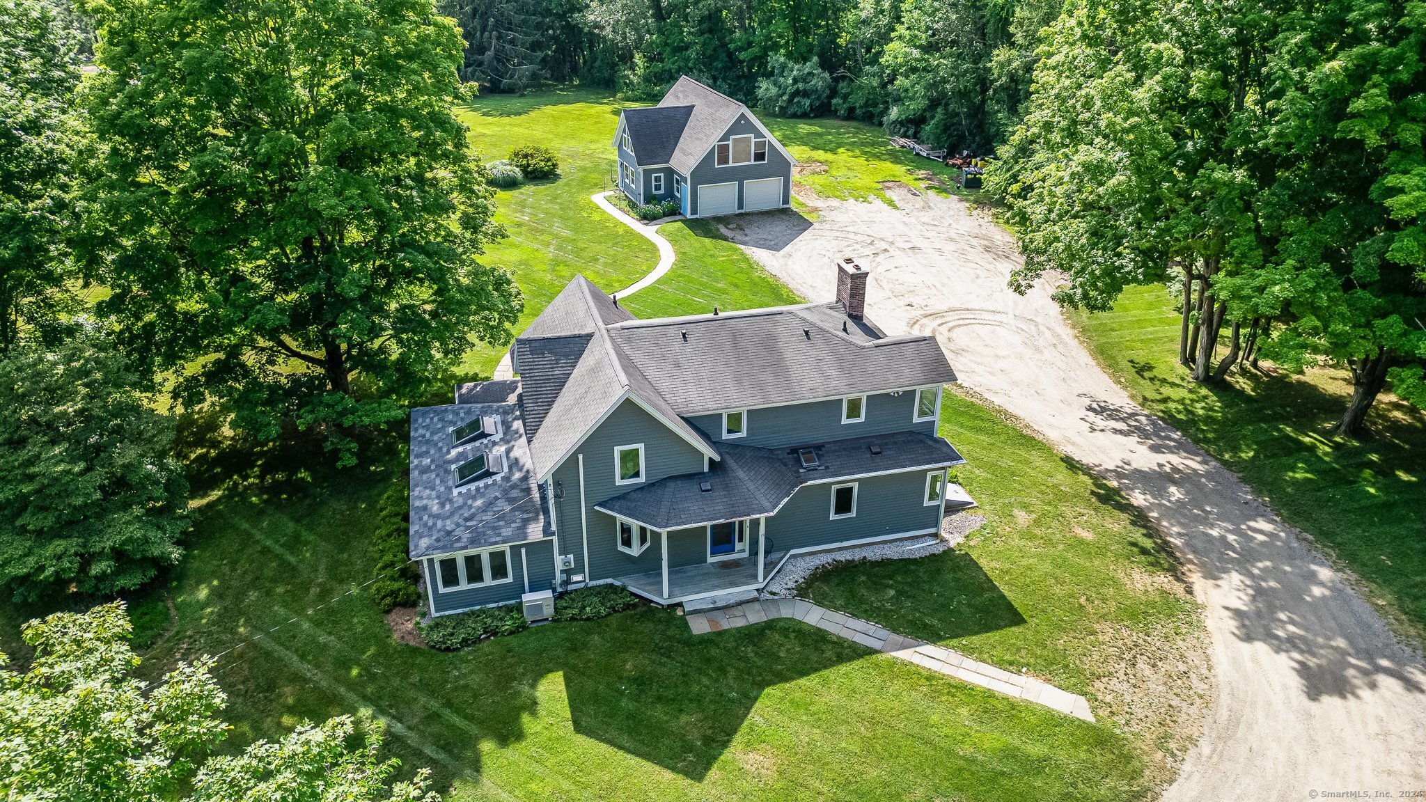 an aerial view of a house with swimming pool a yard and a fountain