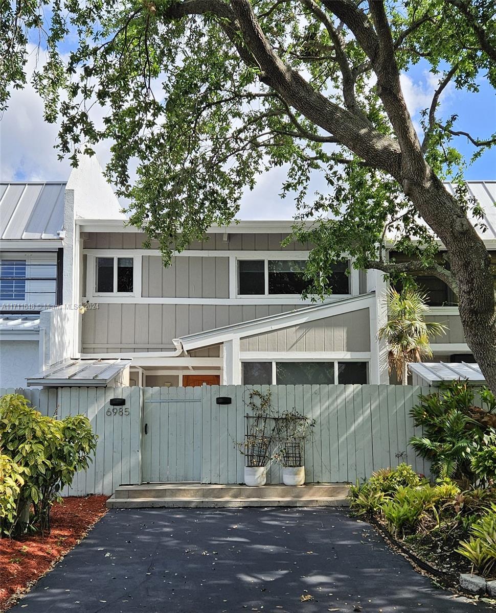 front view of a house with a tree