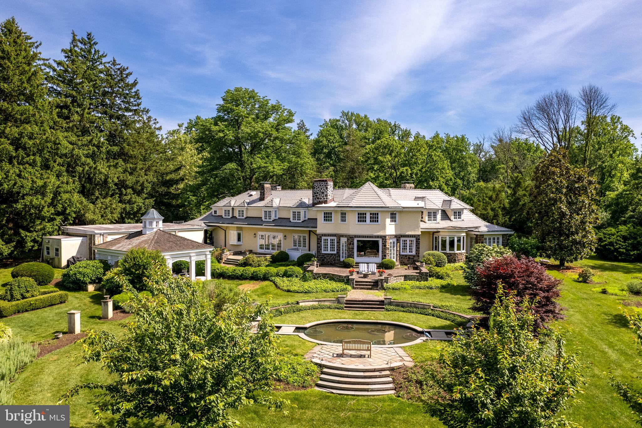 a view of a house with swimming pool and yard