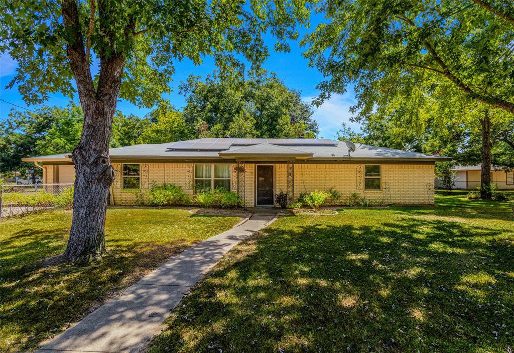 a view of a house with a yard and tree s