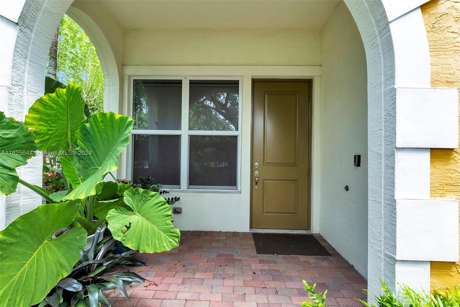 a front view of a house with a garden