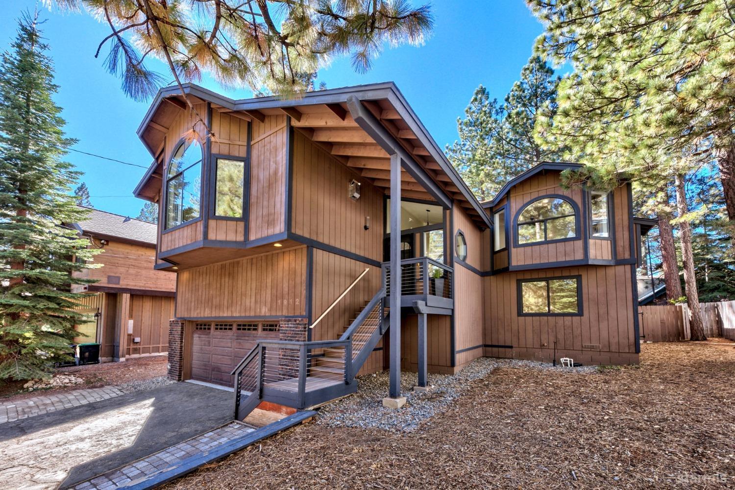 a front view of a house with a tree