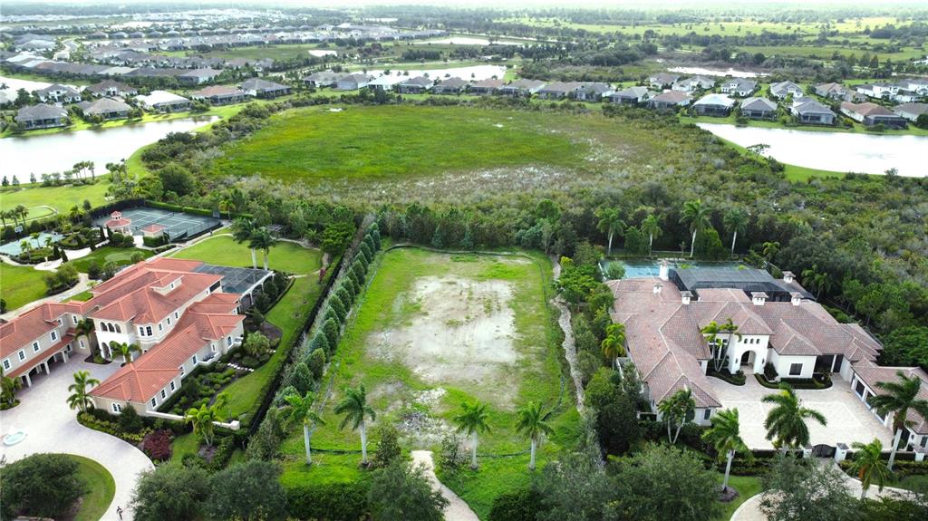 an aerial view of residential houses with outdoor space and river