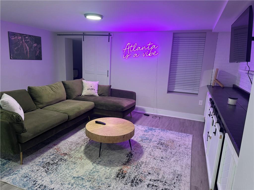 a living room with furniture a rug and a lamp