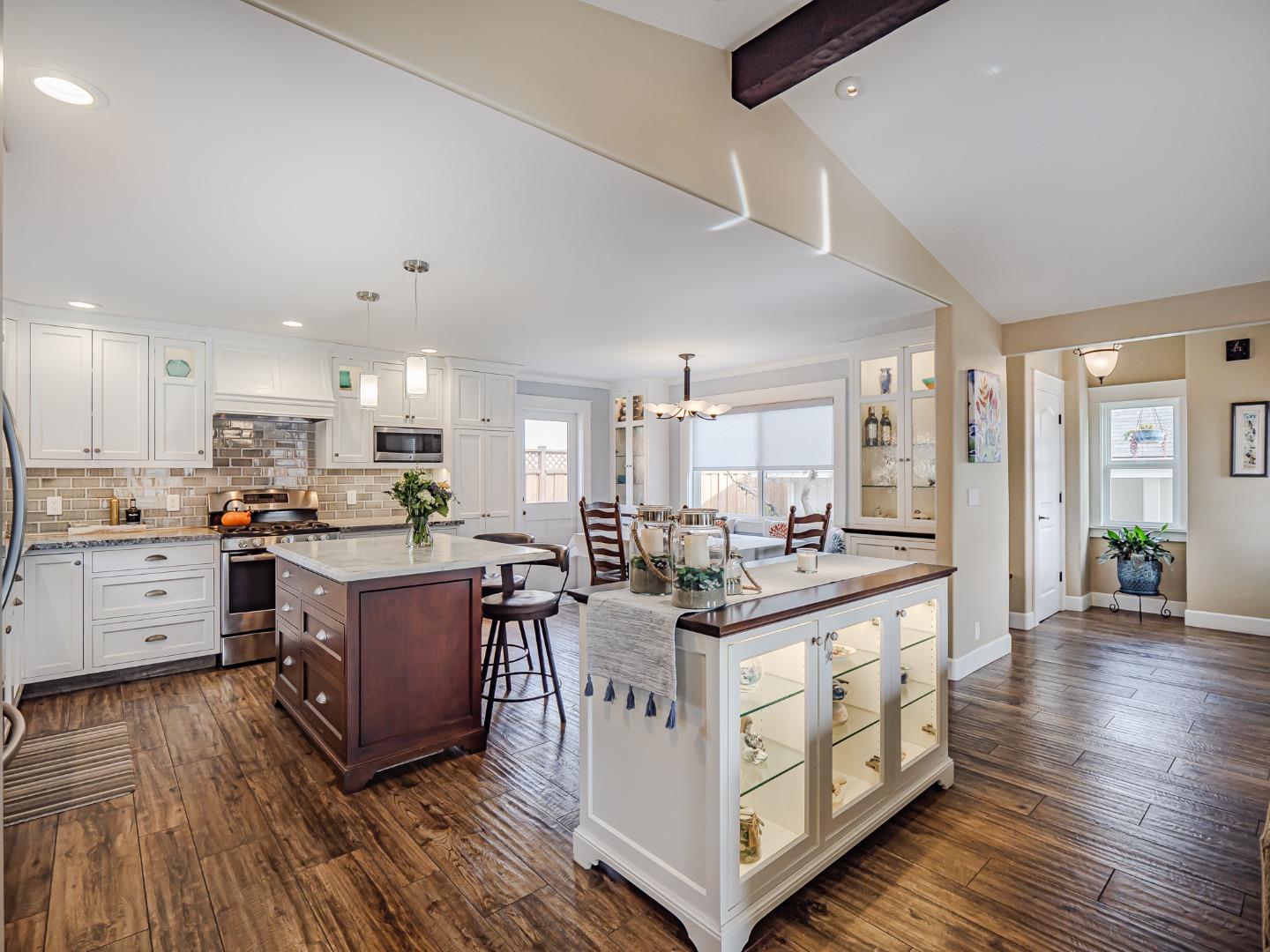 a kitchen with stainless steel appliances granite countertop a stove and cabinets