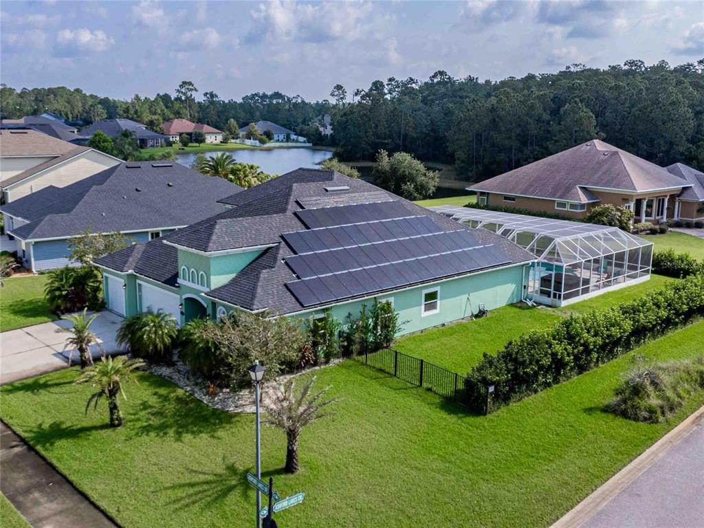 an aerial view of a house with garden space and street view