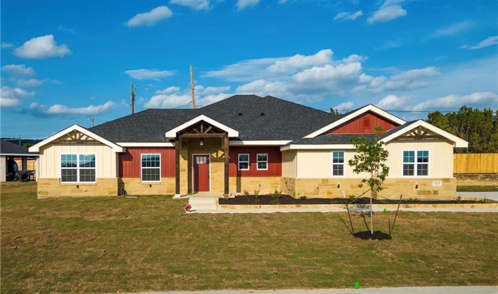 a front view of a house with yard and ocean view