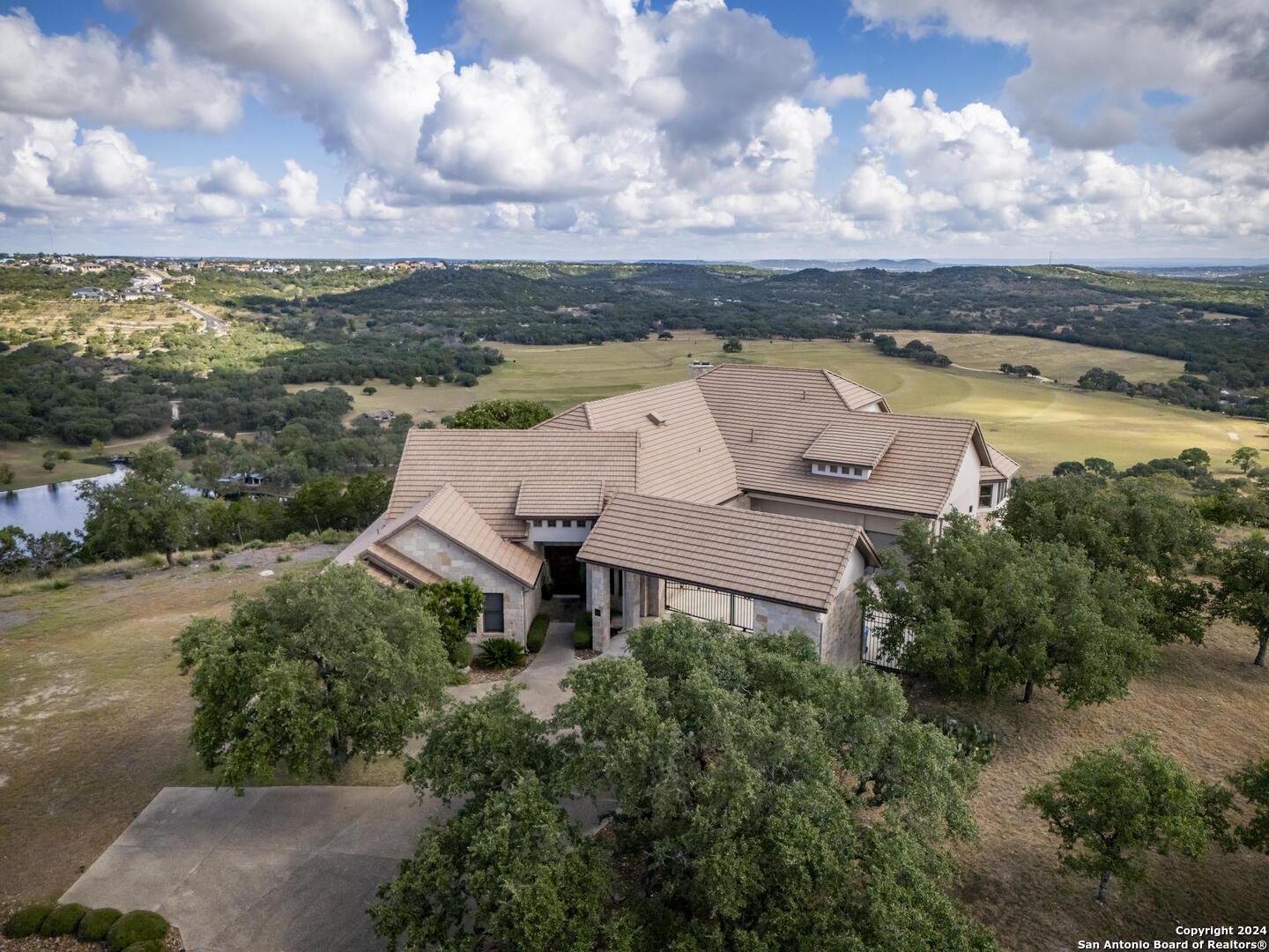 an aerial view of a house with garden space and ocean view