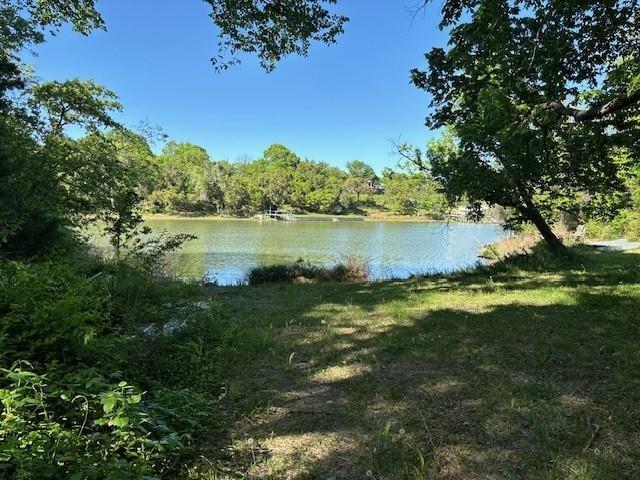 a view of a lake with houses in the back