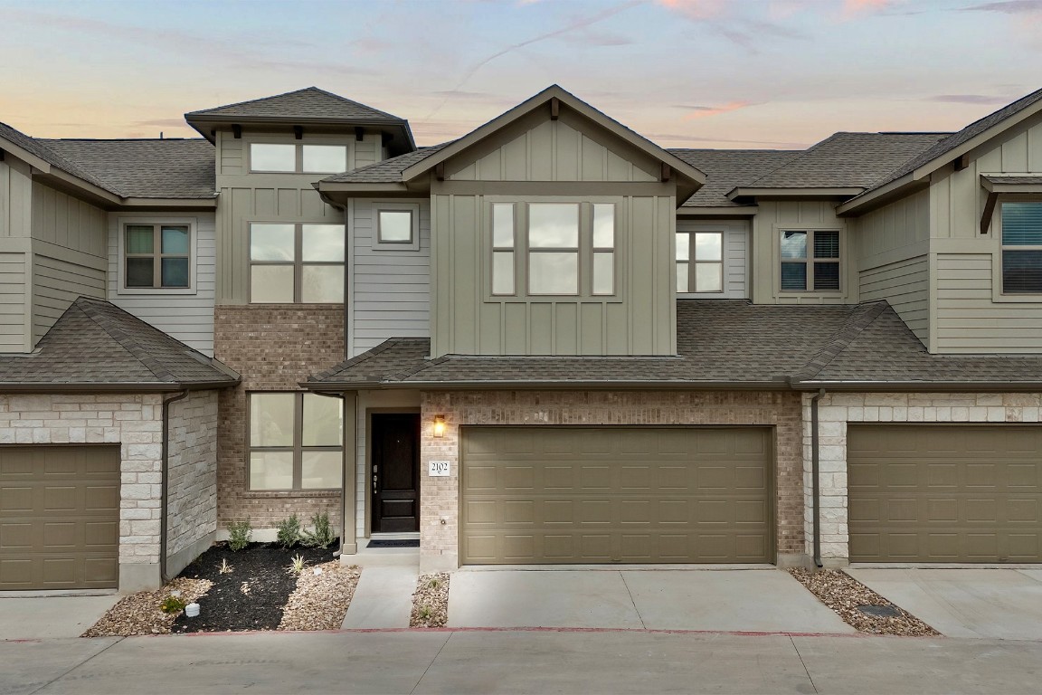 a front view of a house with garage