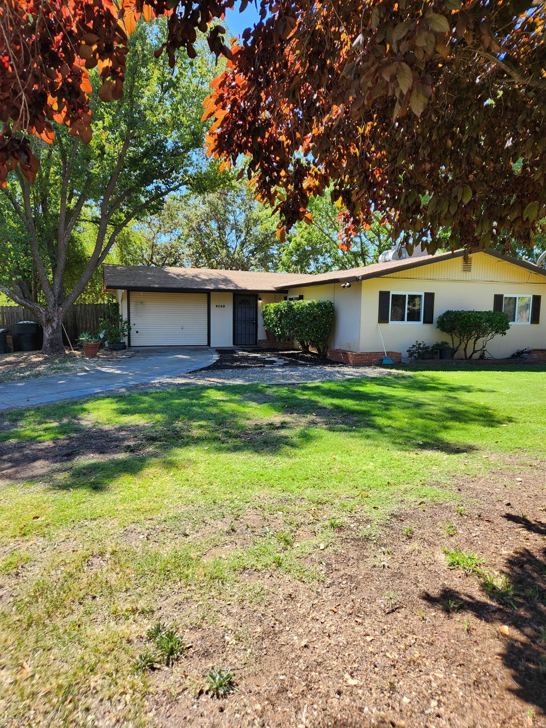 a view of a house with a yard and sitting area