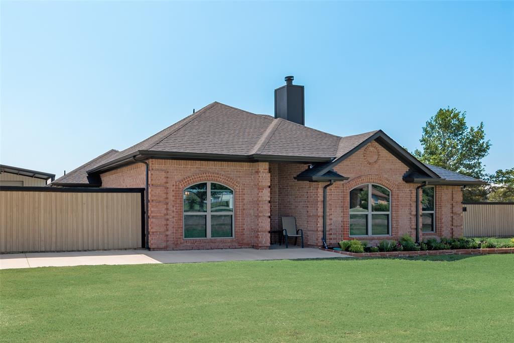 a front view of a house with a garden and yard