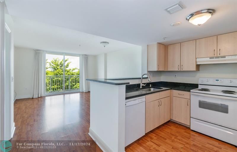 a kitchen with a sink window and cabinets