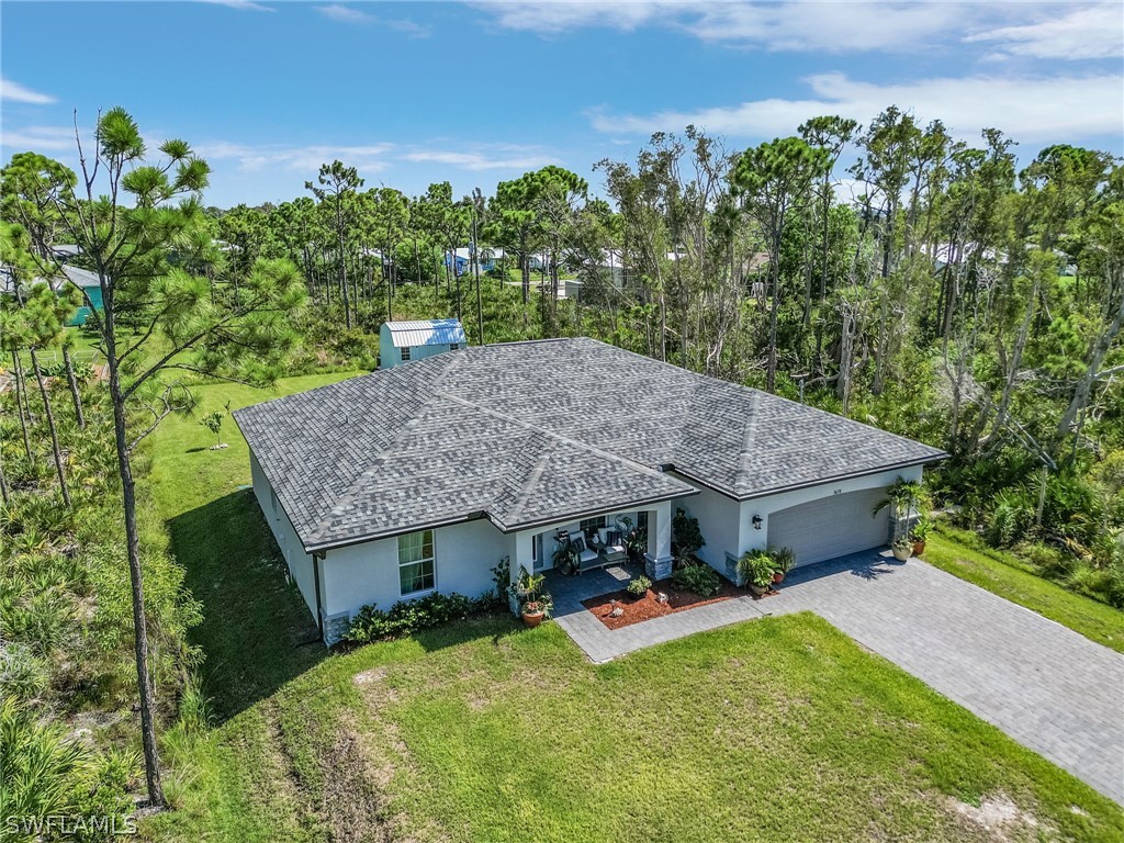 an aerial view of a house having yard table and chairs