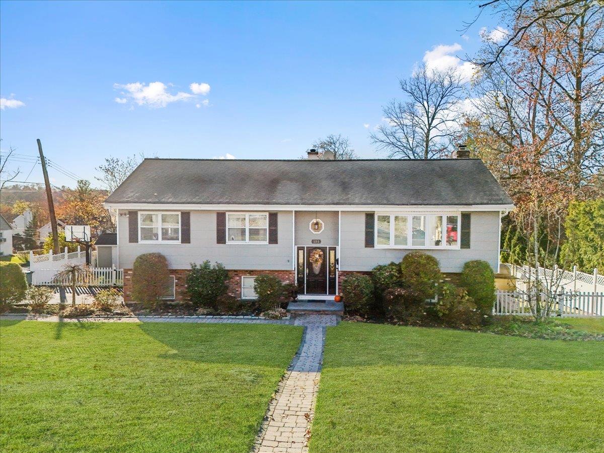 a front view of a house with a garden