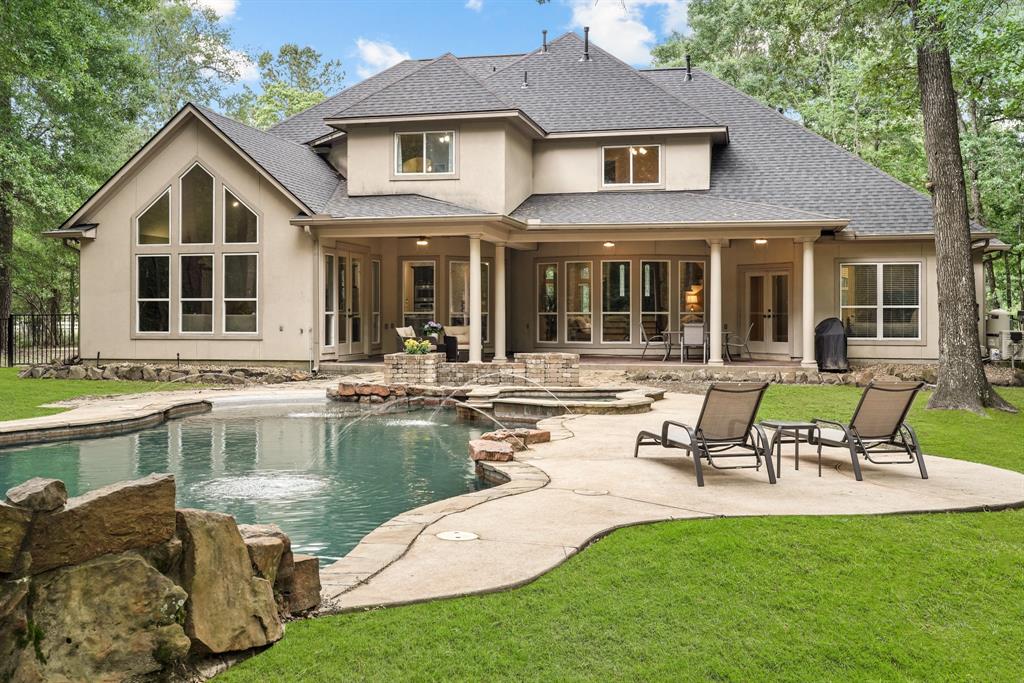 a swimming pool with outdoor seating and yard