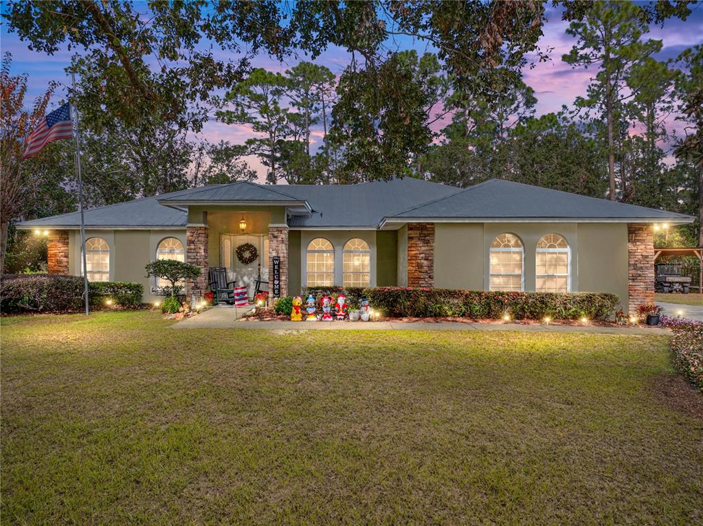 a front view of a house with swimming pool and porch