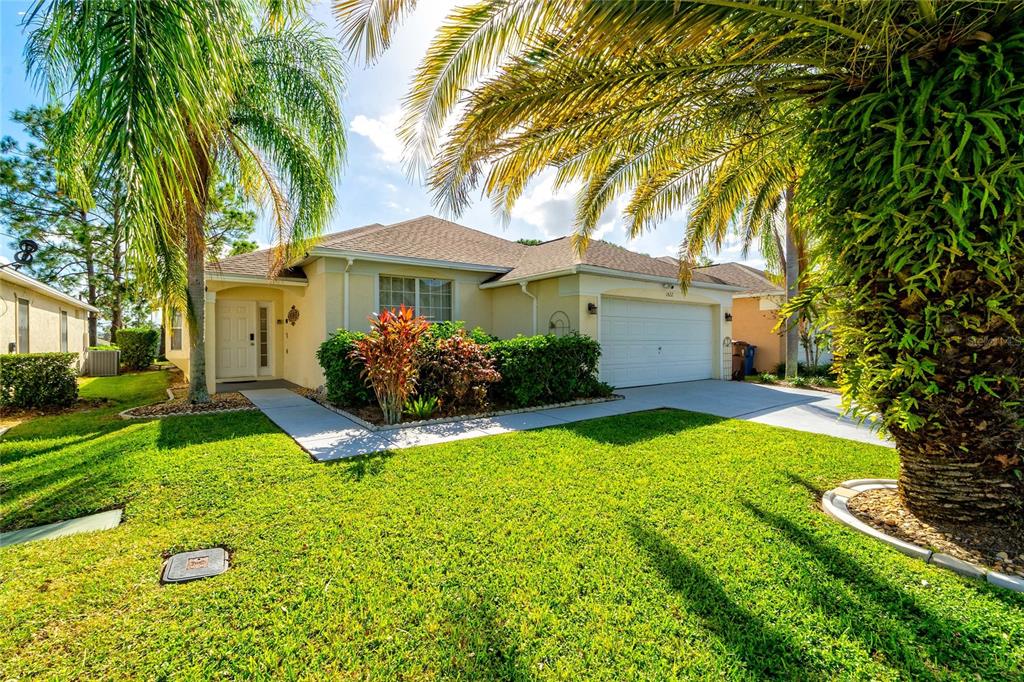 a front view of a house with yard and green space