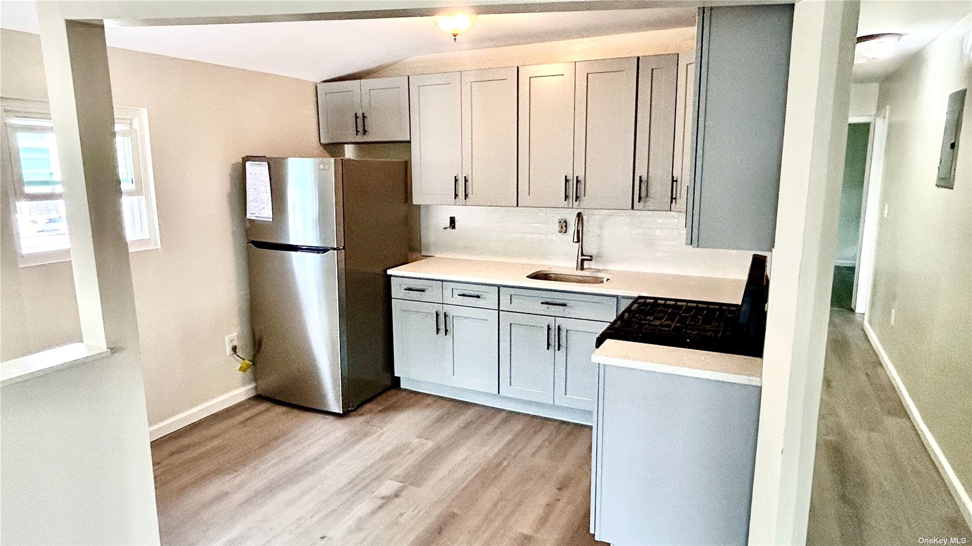 a kitchen with a refrigerator sink stove and cabinets