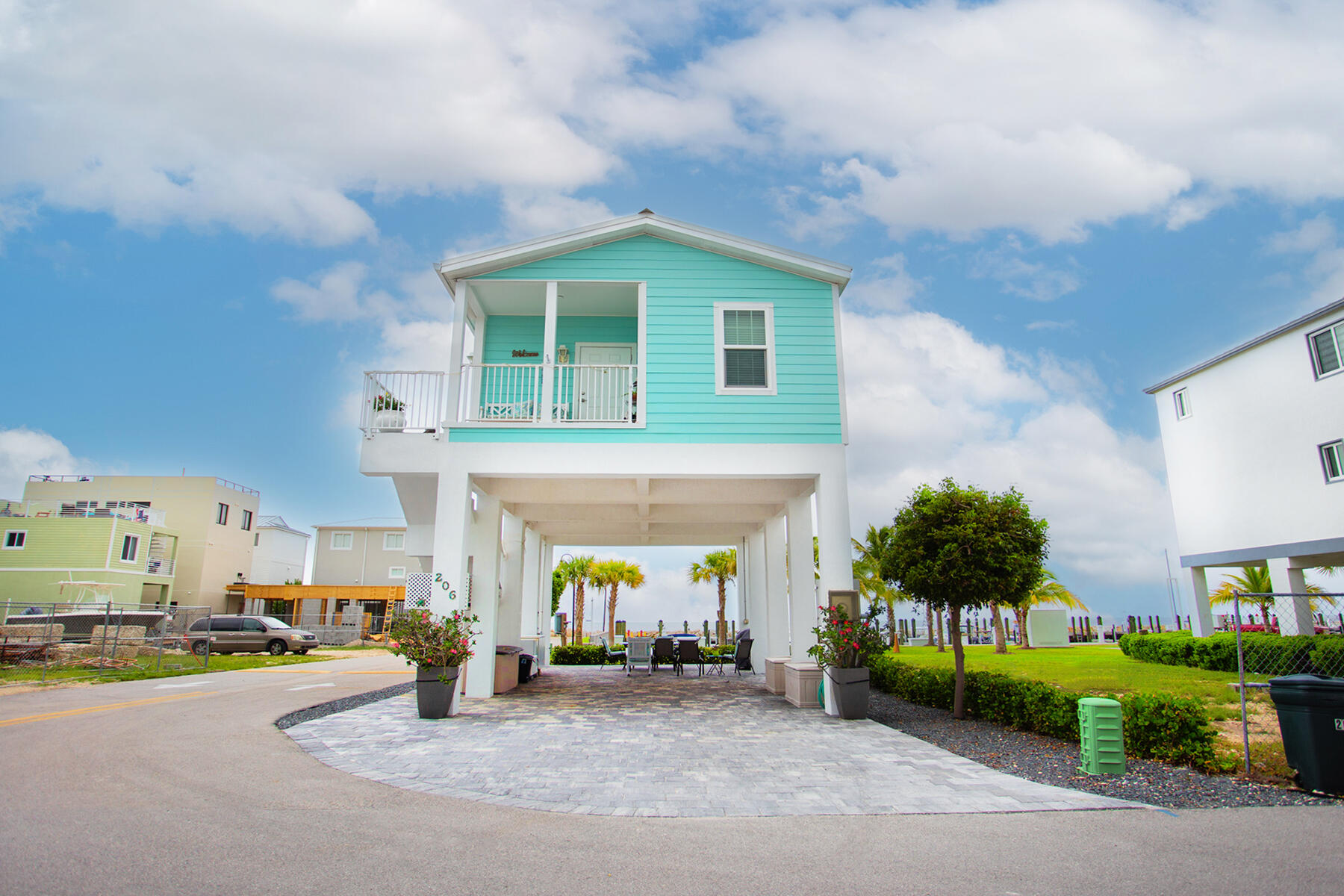 a view of a house with a patio and a yard