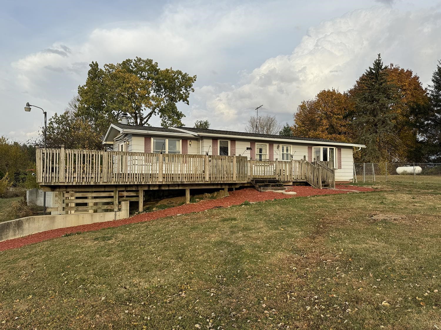 a view of a house with wooden floor and a yard