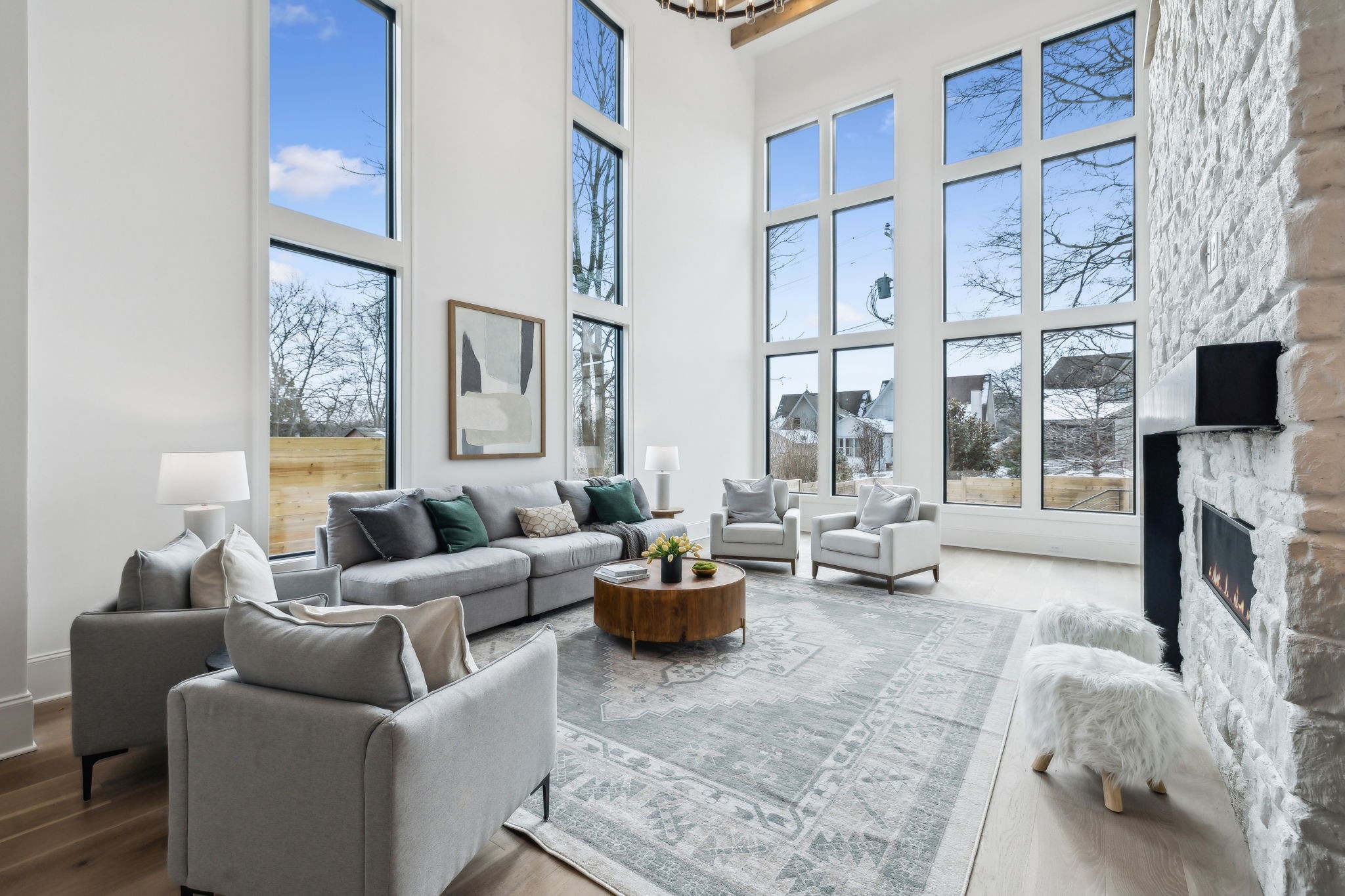 a living room with furniture large window and flat screen tv