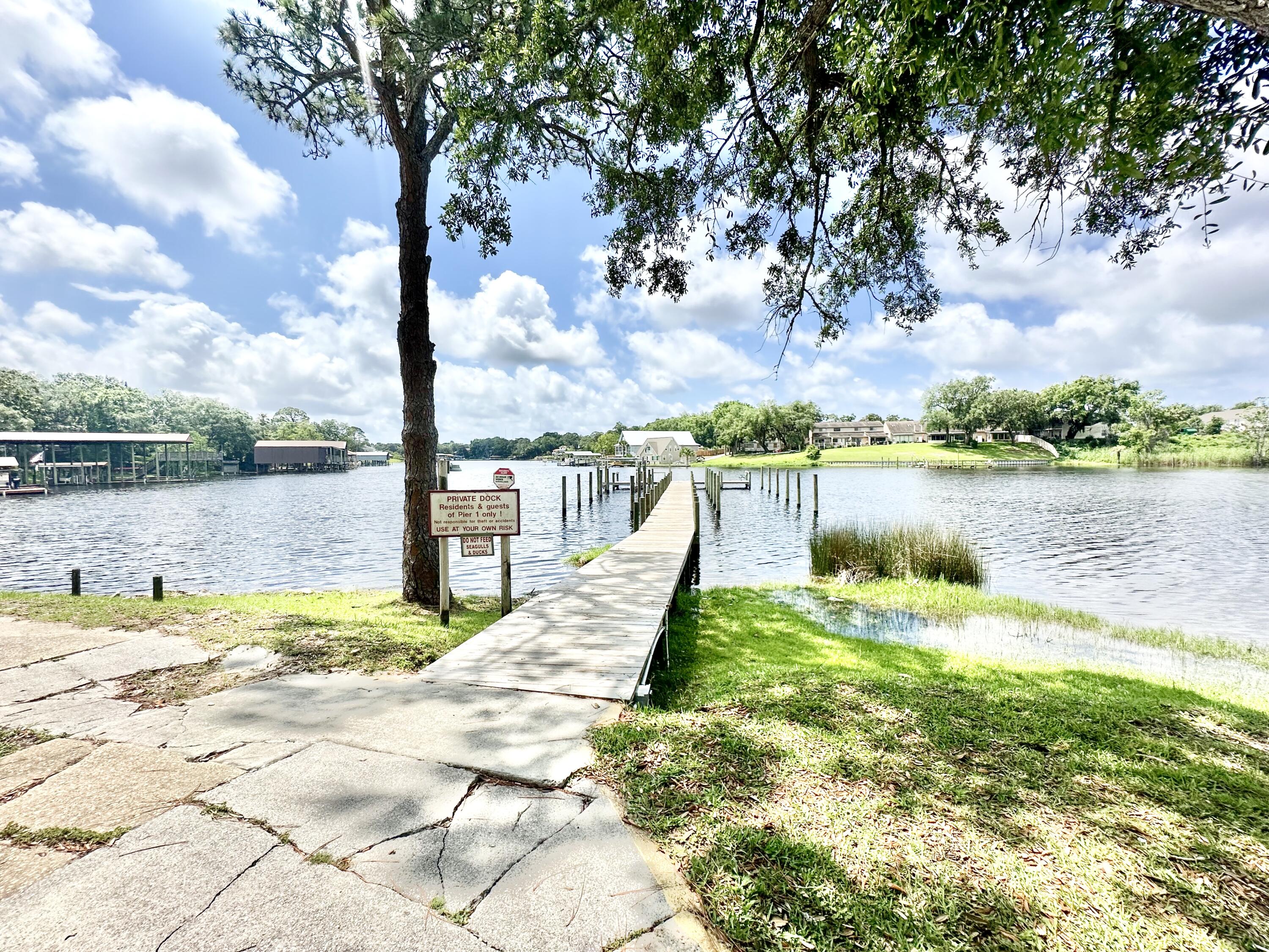 a view of a lake with houses in the back