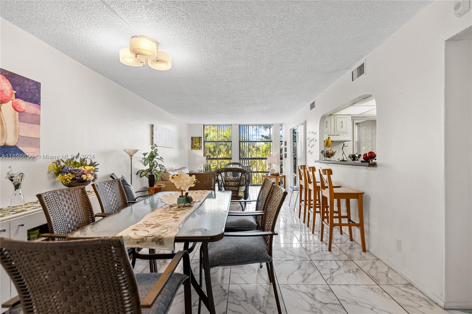 a view of a dining room with furniture and chandelier