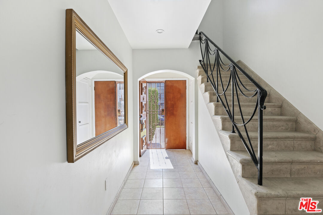 a view of a hallway with entryway wooden floor and front door