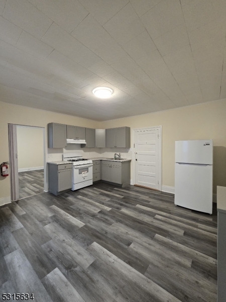 a view of a kitchen with white cabinets and white appliances