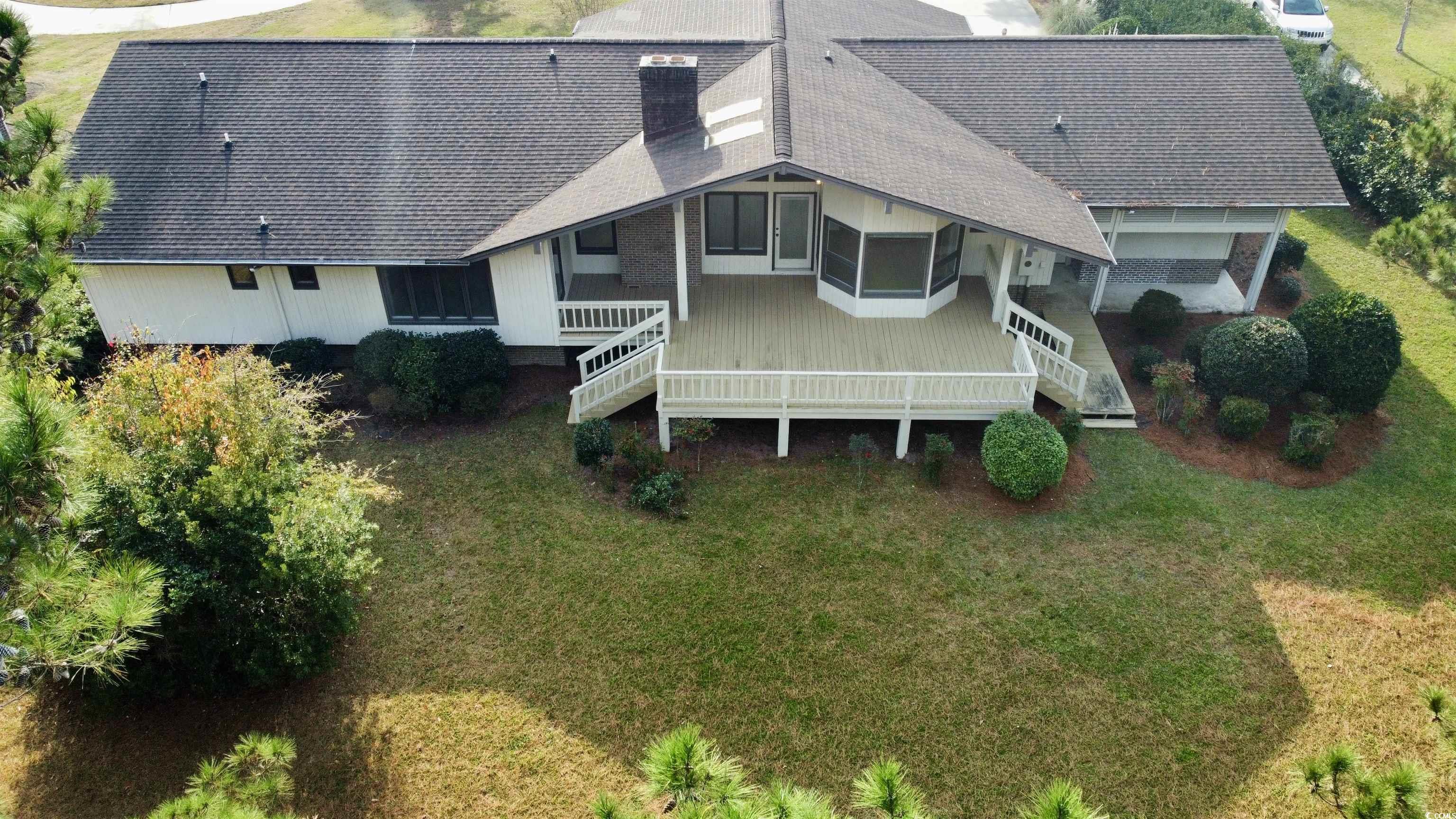 rear of house featuring backyard and large deck /