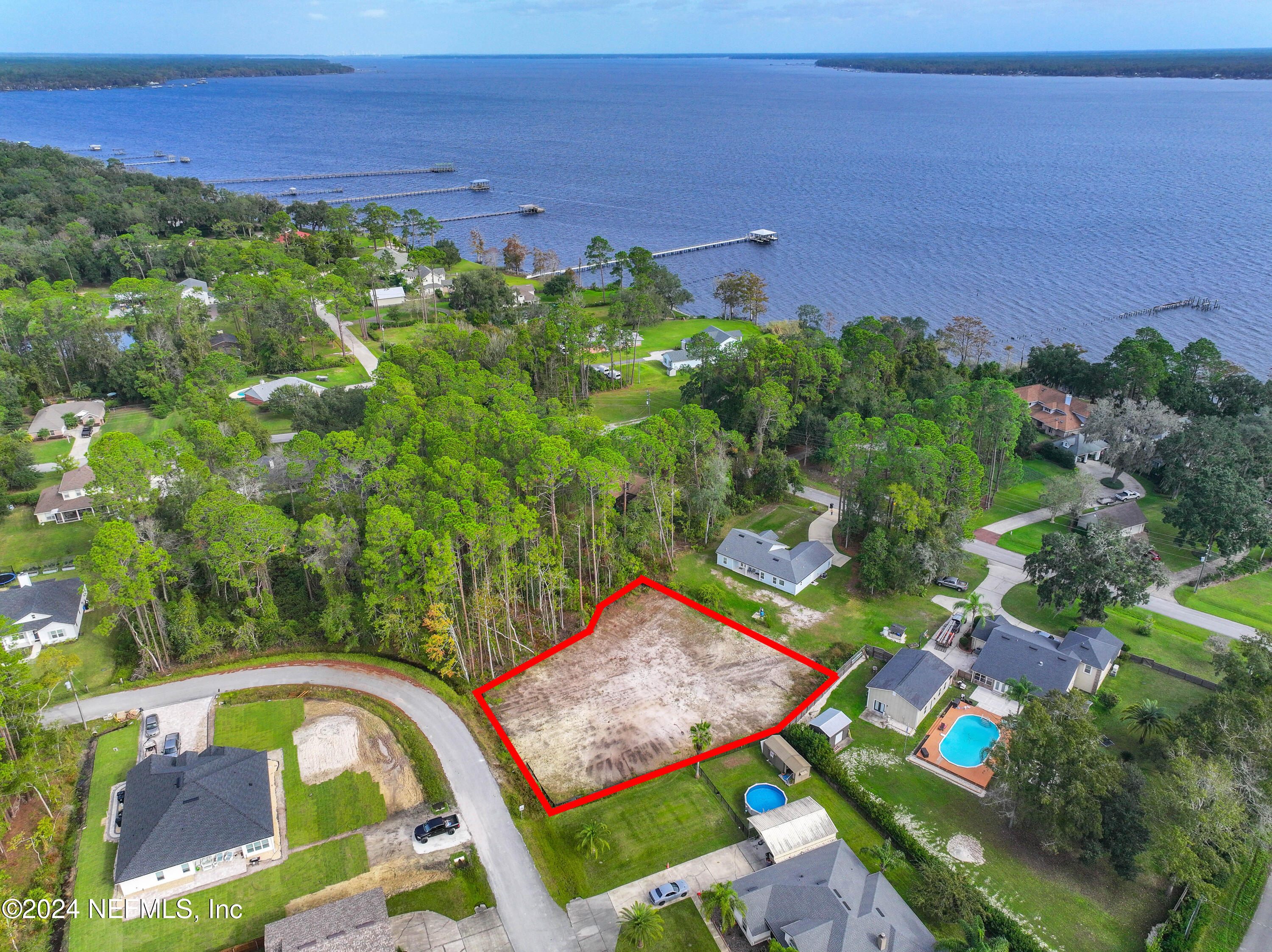 an aerial view of a house yard swimming pool and outdoor seating