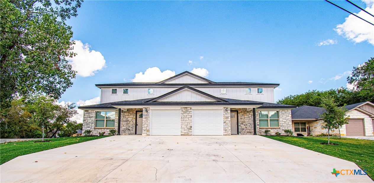 a front view of a house with a yard and garage