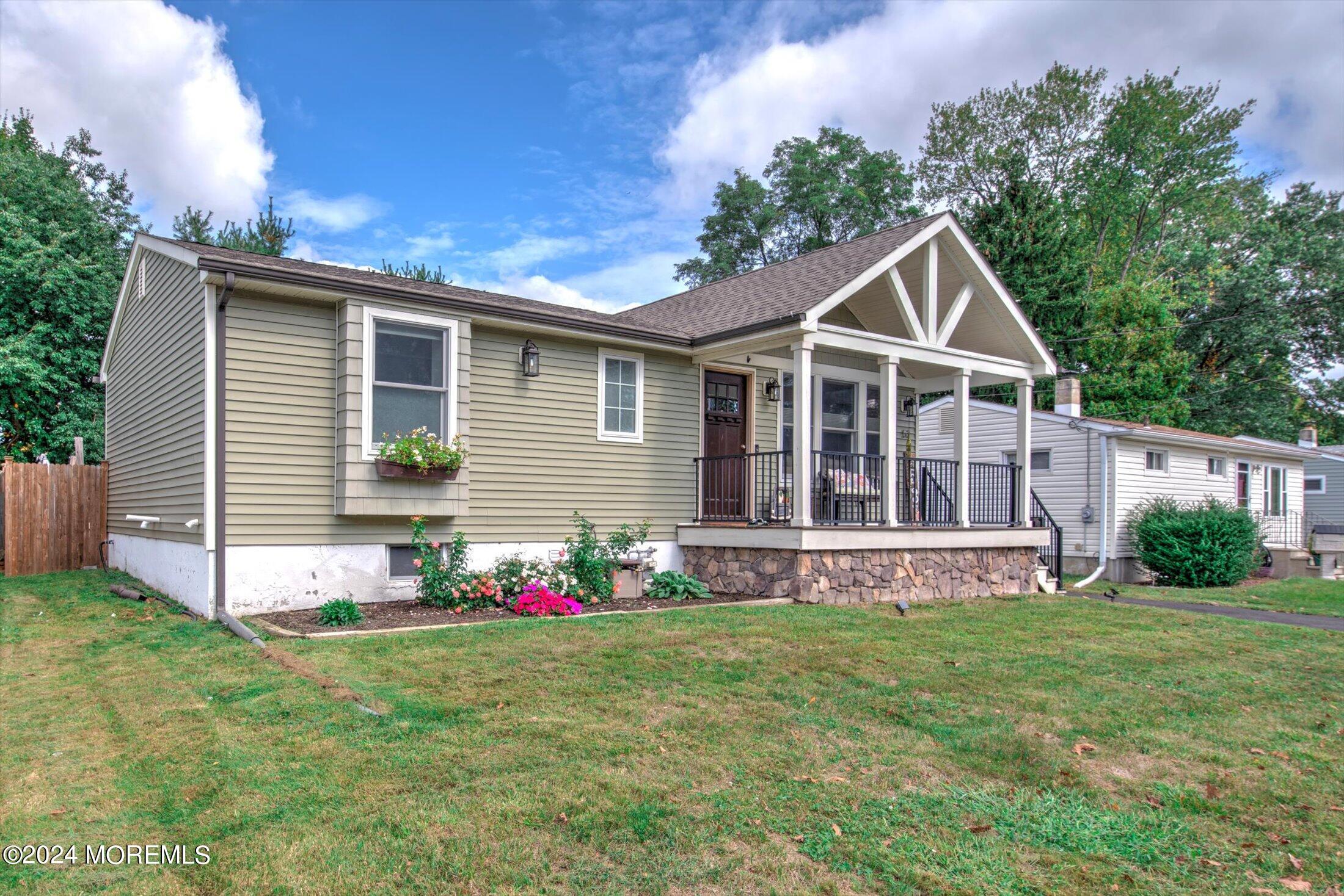 a front view of house with yard and green space