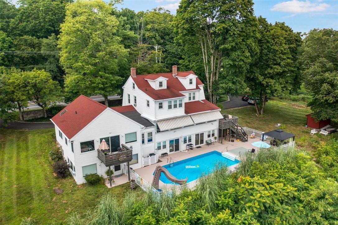 an aerial view of a house with swimming pool and garden