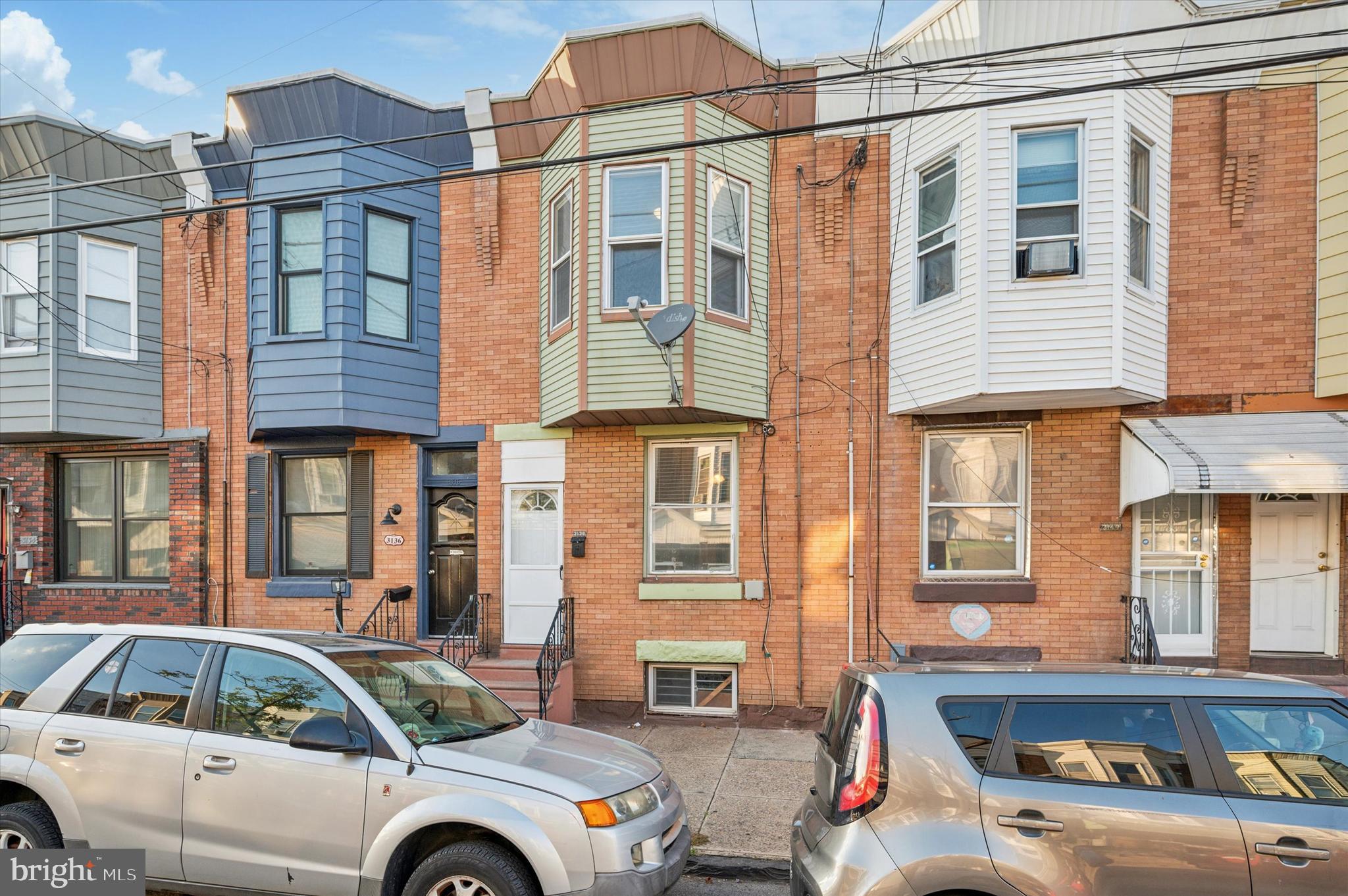 a front view of a residential apartment building with a yard