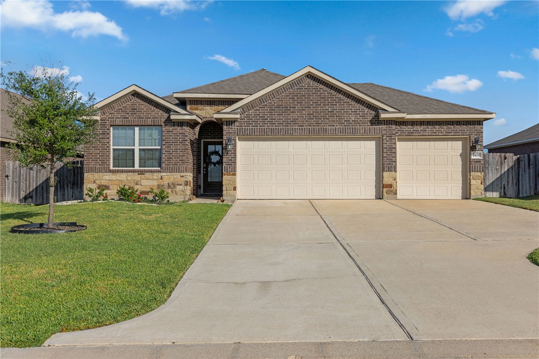 View of front of property featuring a garage and a