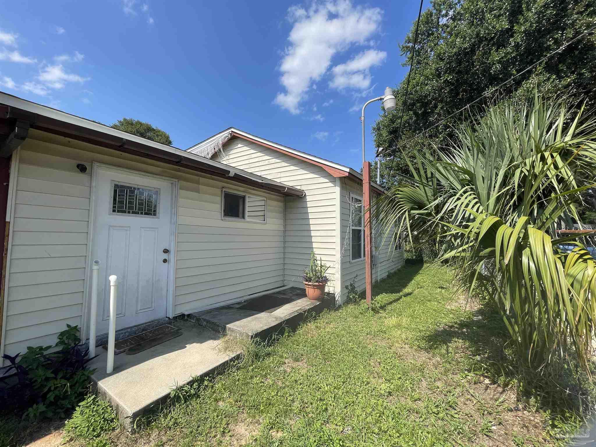 a back view of a house with a yard