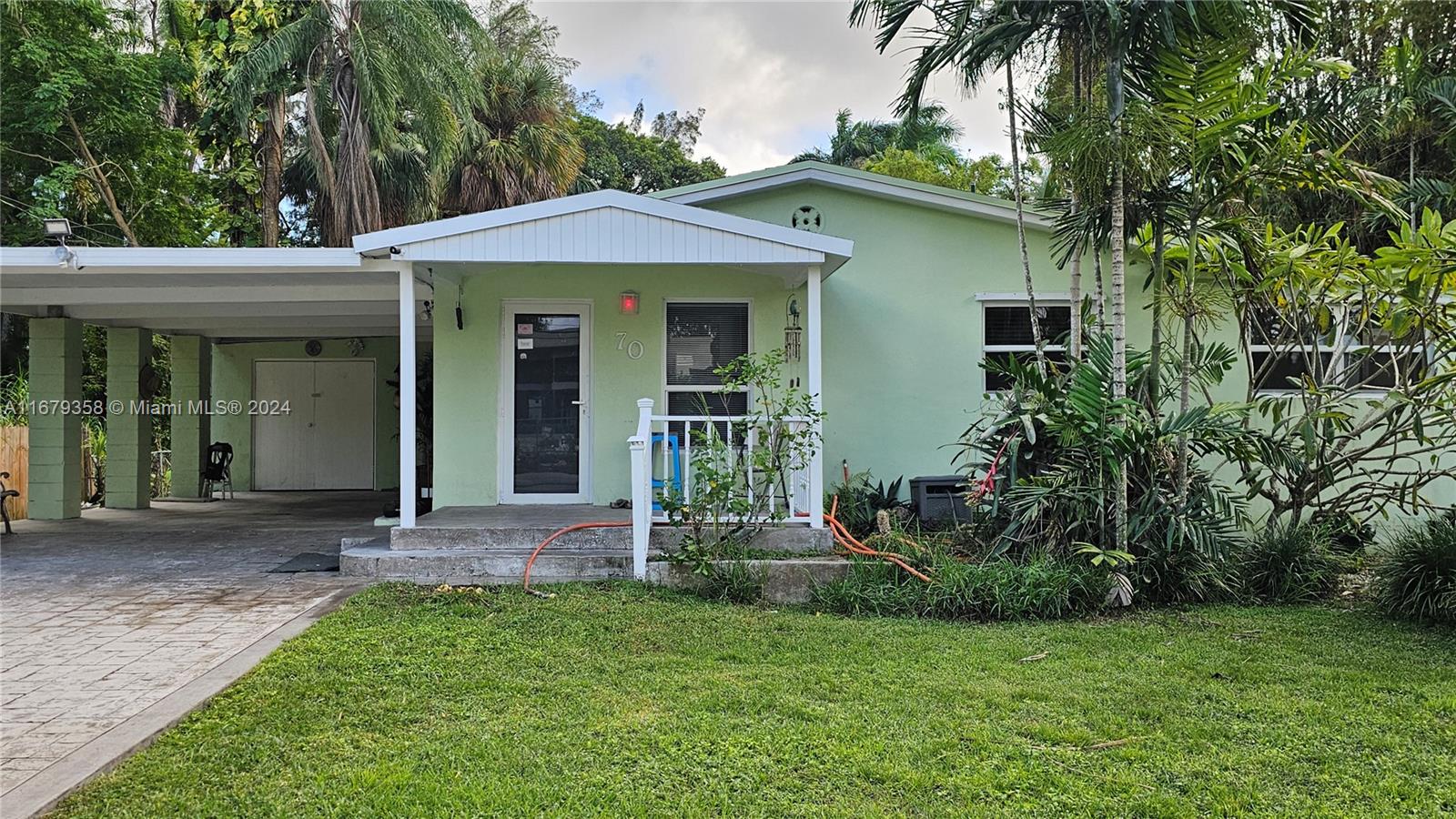 a front view of a house with a garden