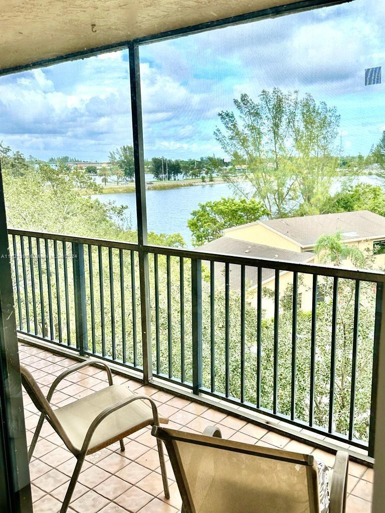 a view of a balcony with furniture