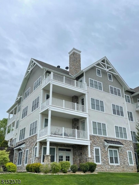 a front view of a residential apartment building with a yard