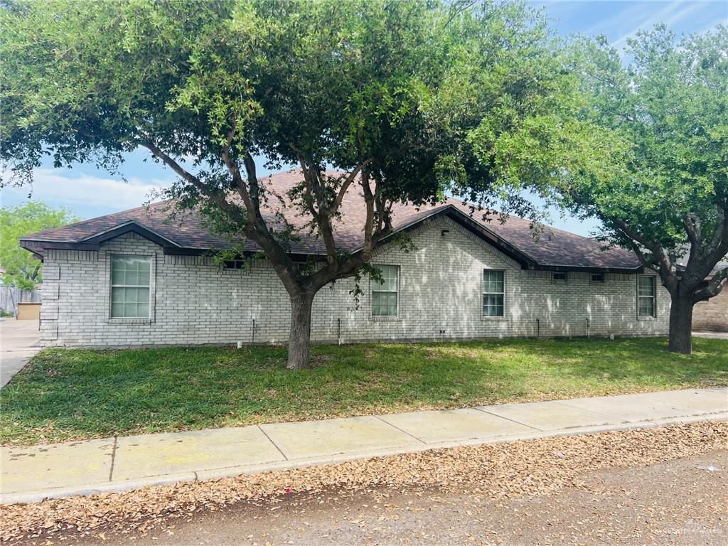 a house that has a tree in front of it