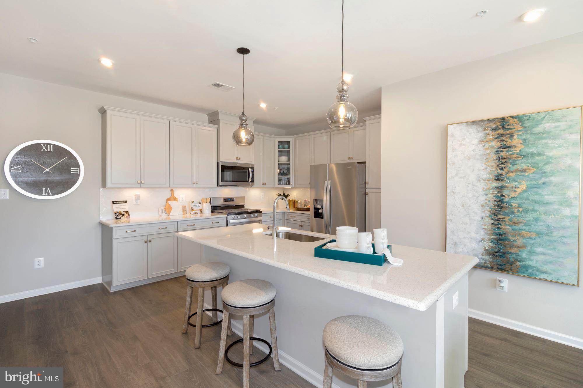 a kitchen with a dining table chairs sink and stove