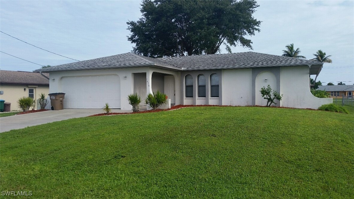 a front view of a house with a garden and plants