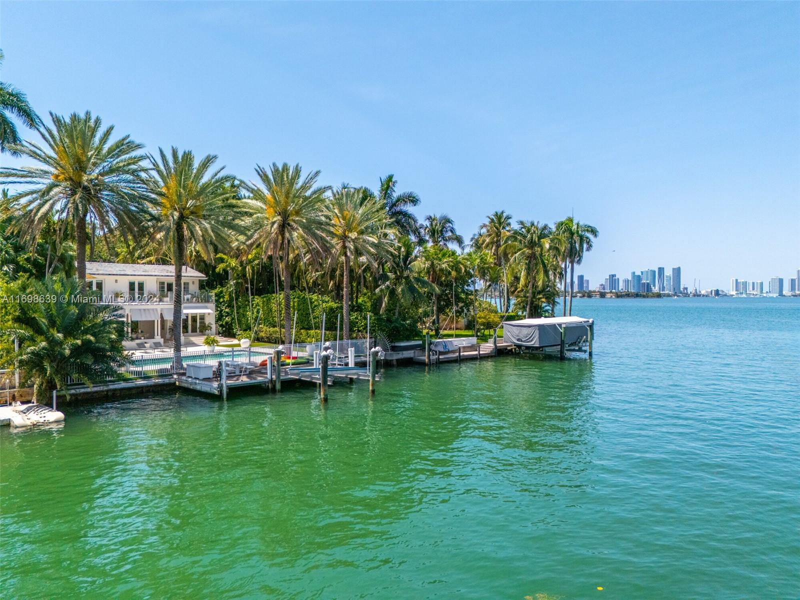 a view of a ocean with boats and trees in the background