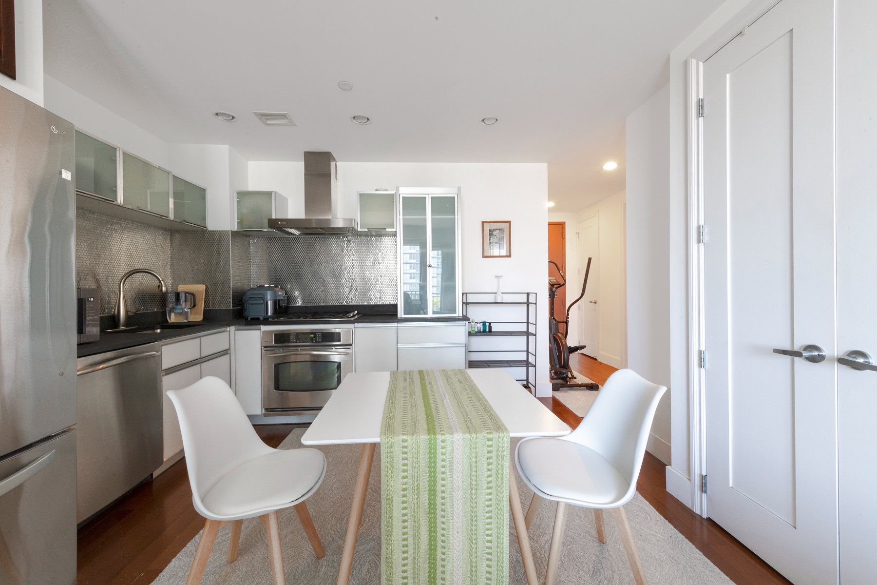 a kitchen with white cabinets and stainless steel appliances