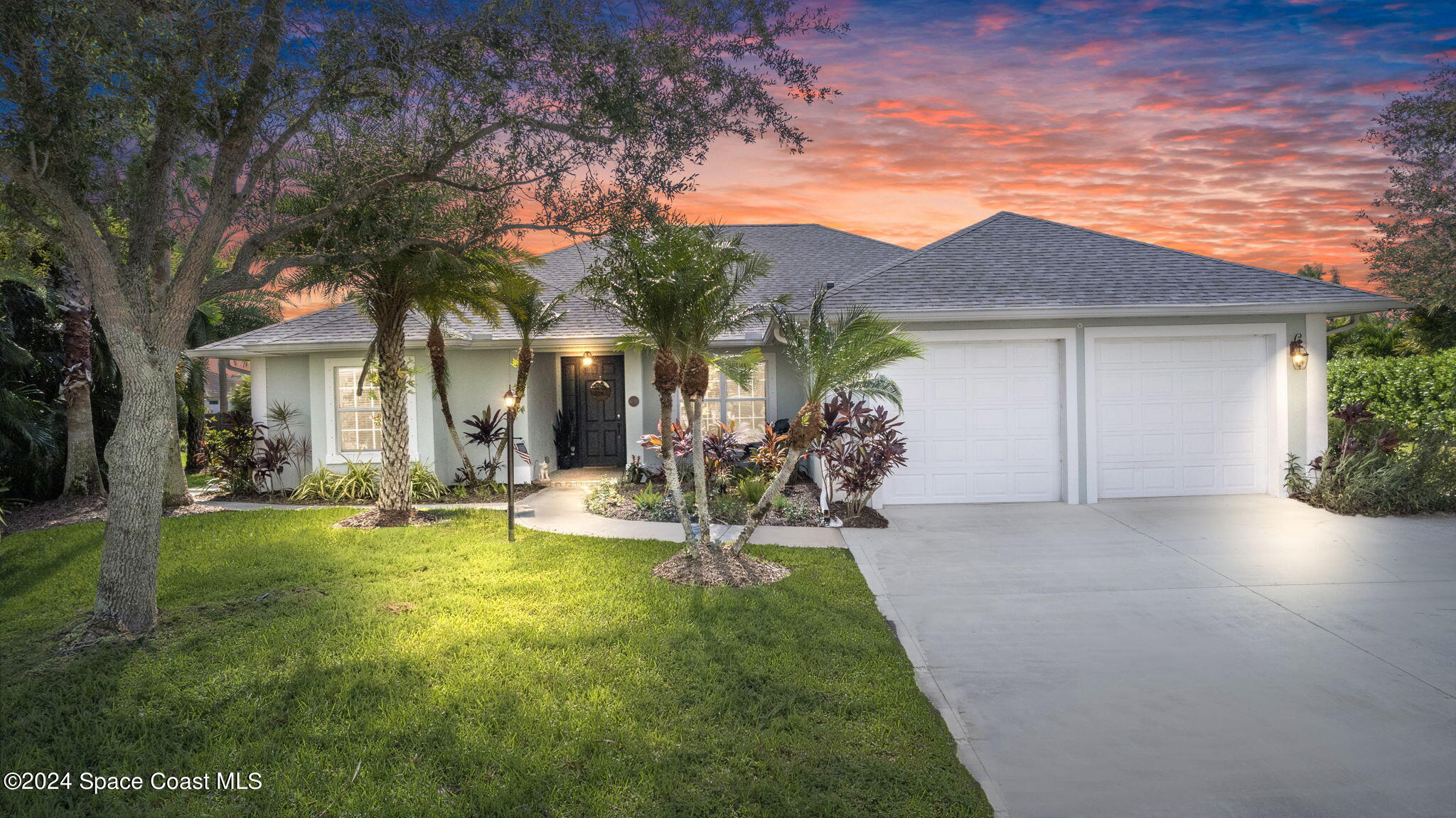 a view of a house with patio and a garden