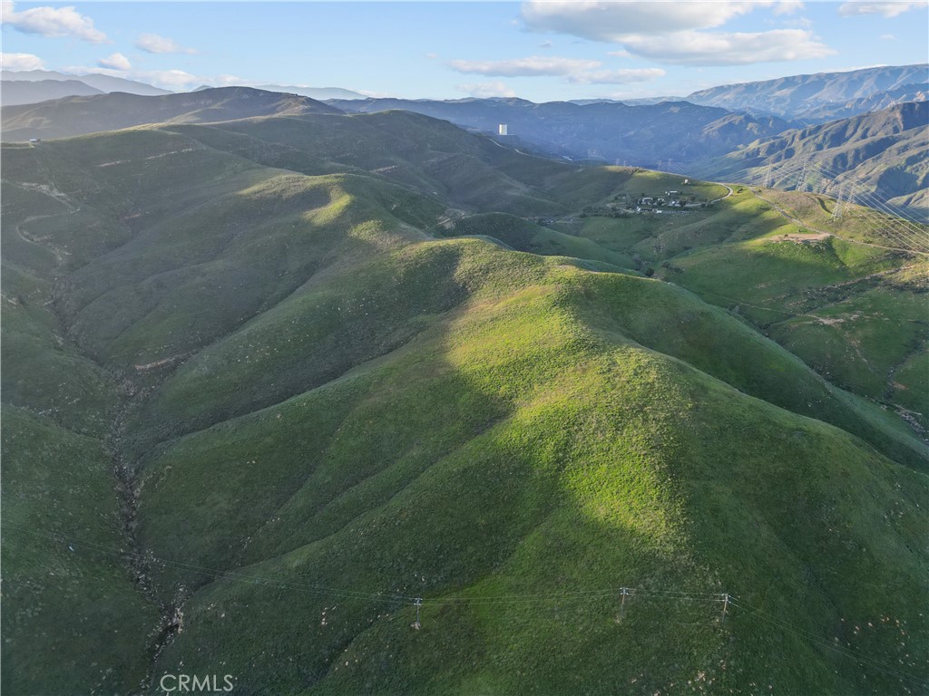 a view of a mountain range with lush green hillside