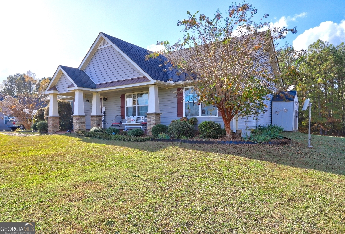 a front view of house with yard and trees around