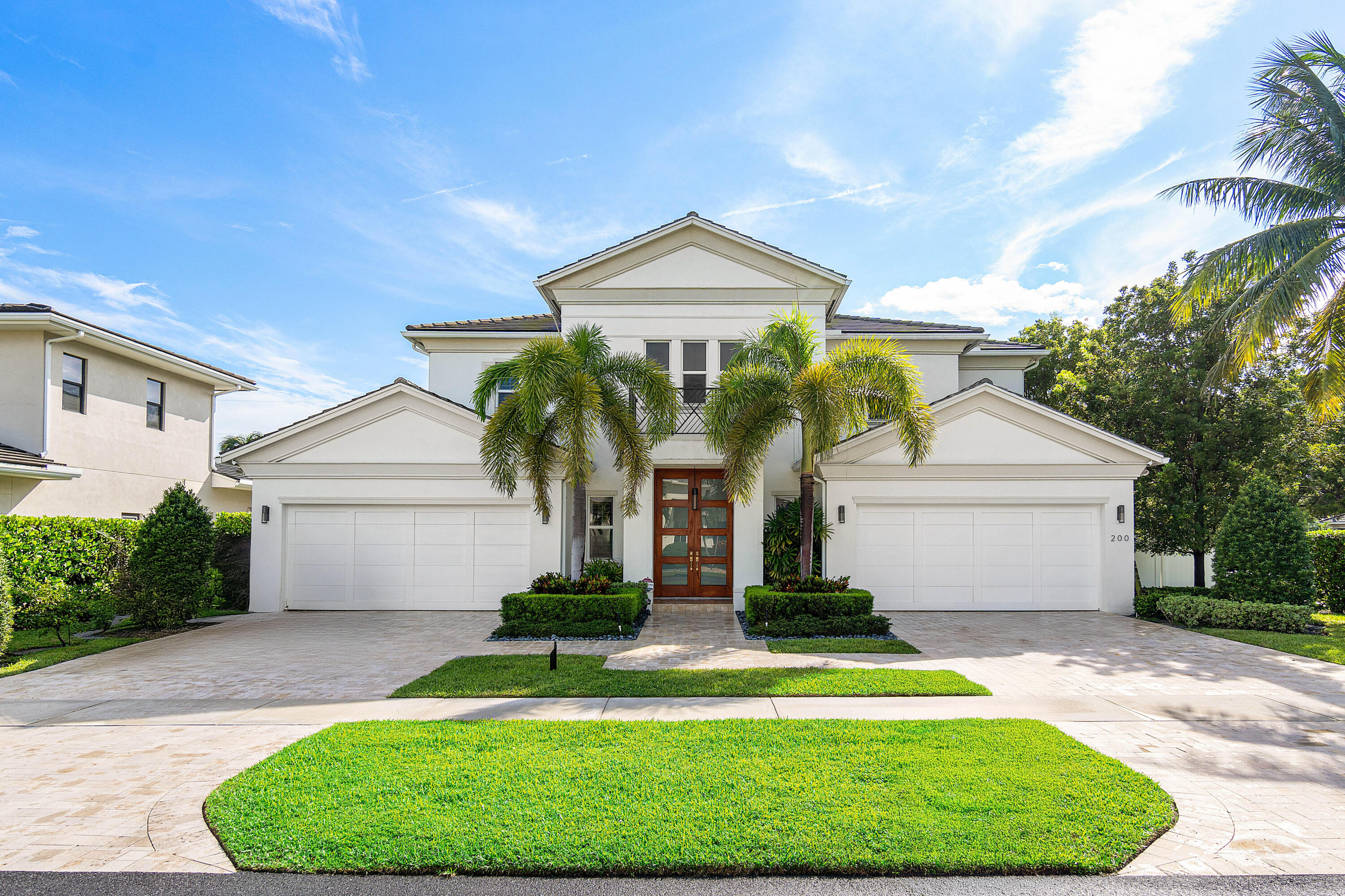 a front view of a house with a garden and plants